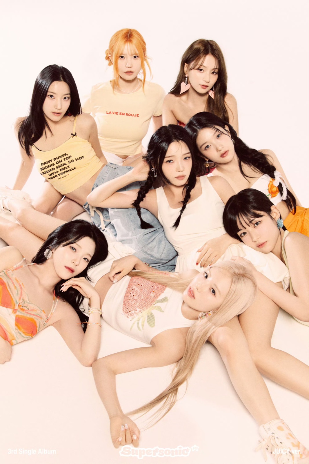 Eight members of fromis_9 posed together against a pale pink background for Supersonic.