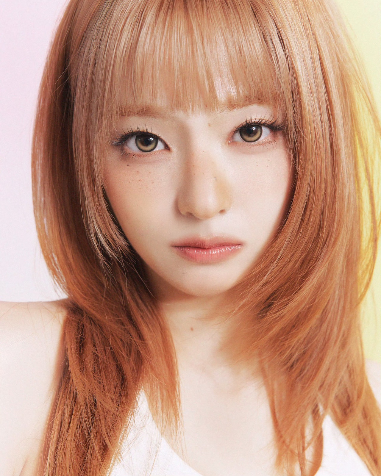 Close portrait of a fromis_9 member with copper-coloured hair.